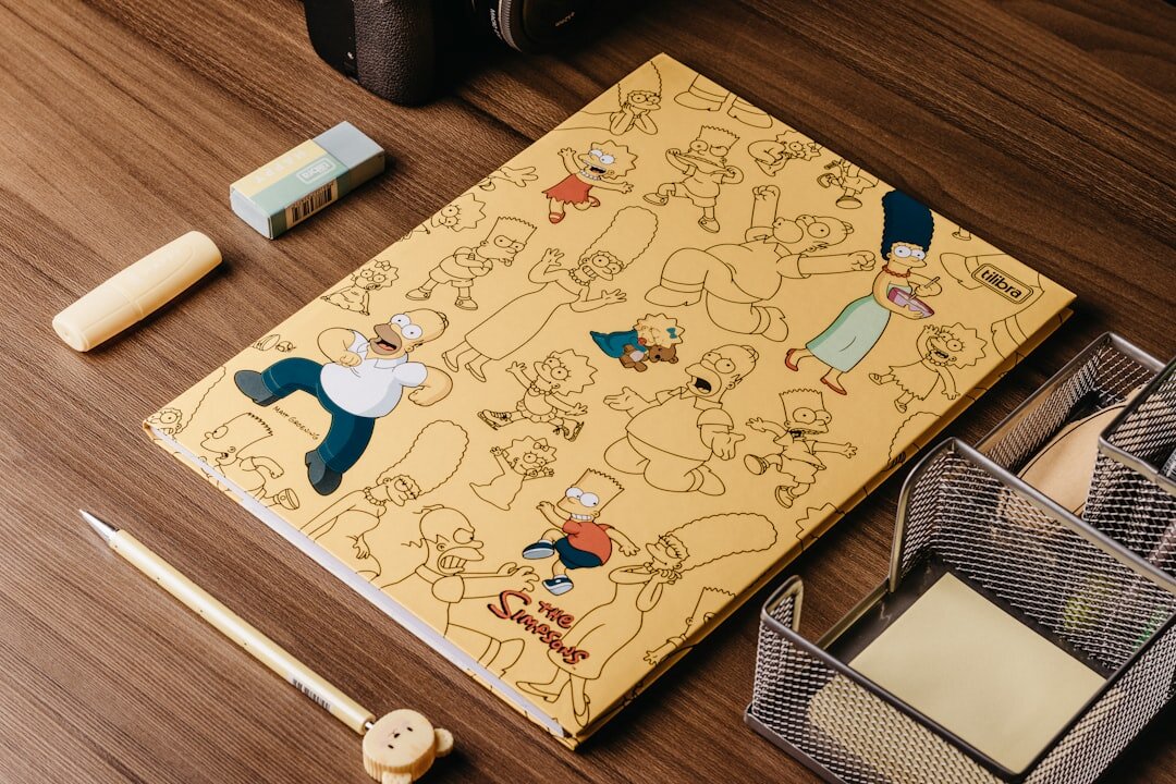 Printed storybook and photographs laid out on a wooden table